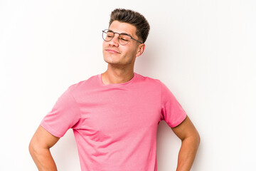 Young caucasian man isolated on white background dreaming of achieving goals and purposes