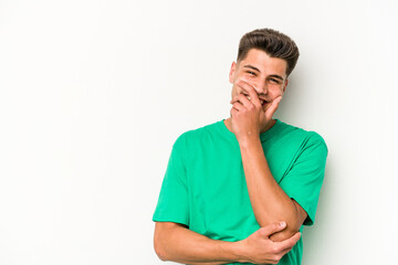 Young caucasian man isolated on white background laughing happy, carefree, natural emotion.