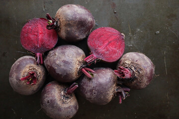 red beets with leaves on dark background 