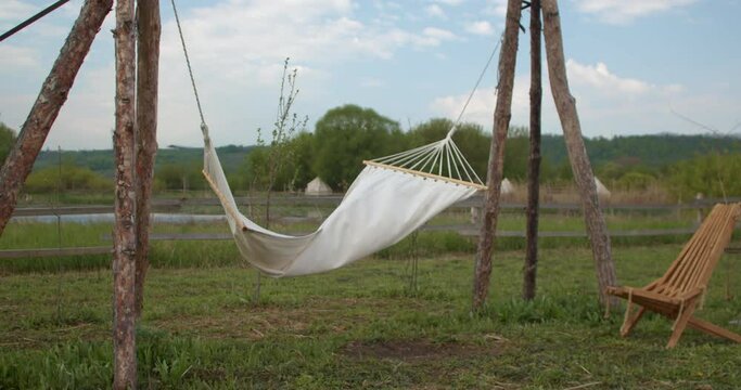 Swaying hammock in windy weather on backyard