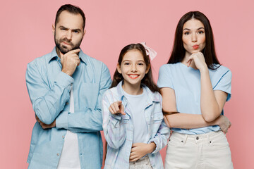 Young minded parent mom dad with child kid daughter teen girl in blue clothes look camera point index finger camera on you isolated on plain pastel light pink background Family day parenthood concept