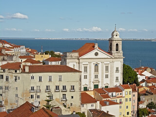 Fototapeta premium Graca church and traditional houses in front of Tagus river in Lisbon, portugal