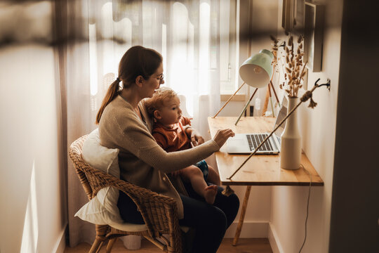 Woman working at home with her baby