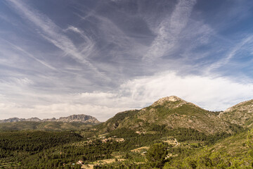 Obraz na płótnie Canvas Mountainous landscape on a sunny day with cloudy blue sky.
