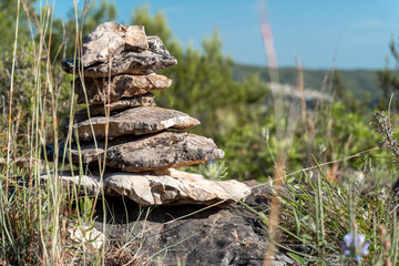 Close-up stacked stones in a natural environment, on a sunny day.