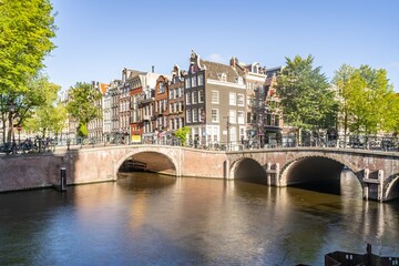 Amsterdam, Netherlands bridges and canals during a sunny day. 