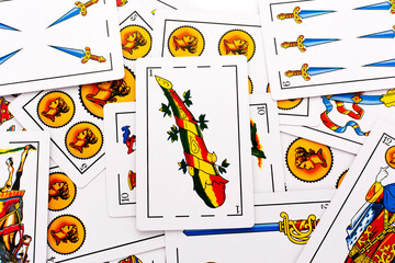 Spanish card game, spanish deck Tarot cards, the wands card in the foreground.
