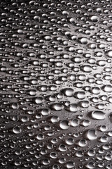 Abstract background with drops of water on metallic flat surface