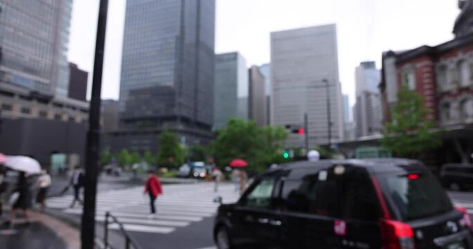 Walking people on the street in Marunouchi Tokyo rainy day