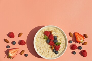 Oatmeal porridge with fresh berries. National Porridge Day, banner. Creative flt layot.