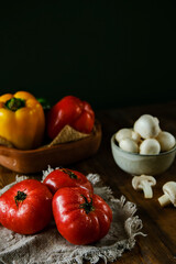 Vegetables on a wooden table. Seasonal vegetables. Tomatoes, peppers, cucumbers, mushrooms on the table.