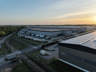 Fototapeta premium Pictures from the drone on the warehouse building. Concept for storing goods, shipping for stores, ecommerce, online stores. Aerial view on warehouses.