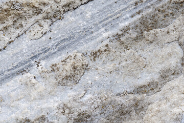 An old gray dirty raw marble stone. For background or texture