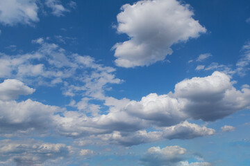 Blue summer sky with white cumulus clouds. Blue sky with clouds nature background.