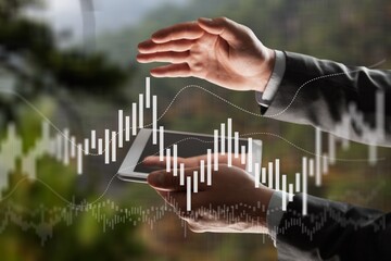 Business man's hand raising amount of CO2 emissions graph concept