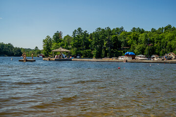 Fototapeta premium Lake Rosseau, Muskoka, Ontario, Canada - People enjoying the summer vacation at lake Rosseau resort