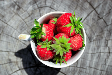 Fresh strawberries in a white mug