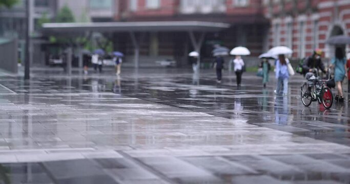Walking people on the street in Marunouchi Tokyo rainy day