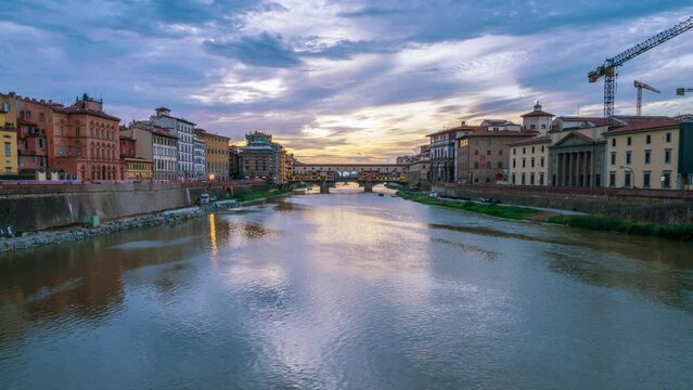 
Time Lapse View of Ponte Vecchio Medieval Bridge During Sunset. Florence Italy. Famous Footbridge Over River Arno. Blurred Brands, Names And Faces.