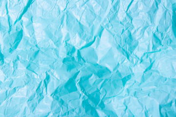 Abstract bright blue background. Squeezed multicolored craft paper