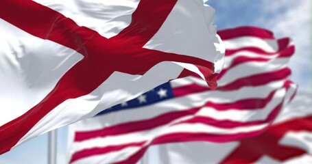 Seamless loop in slow motion with the flags of the Alabama state and United States of America waving in the wind