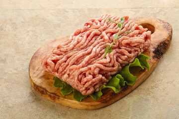 Raw minced pork meat over board