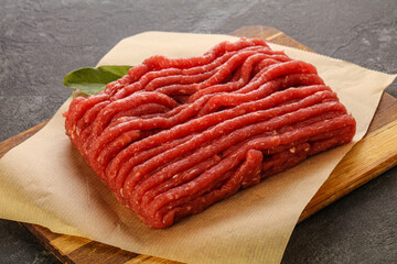 Raw beef minced meat over board