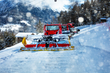Snowcat ratrack machine make snow at ski resort during snowfall