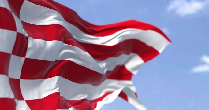Seamless loop in slow motion with the civil flag of Bremen waving in the wind on a clear day