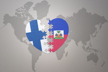 puzzle heart with the national flag of haiti and finland on a world map background. Concept.