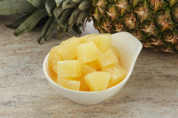 Marinated pineapple slices in the bowl