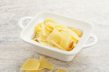 Sliced parmesan cheese heap in the bowl