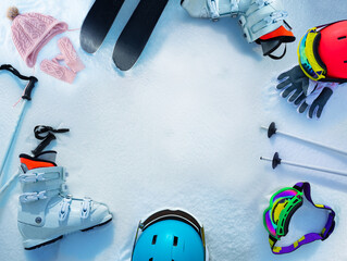 Many different objects ski boots, helmets in snow from above