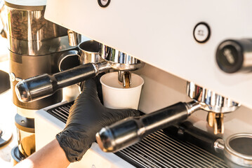 close up of hand pouring coffee from a coffee machine, coffee bike, food concept