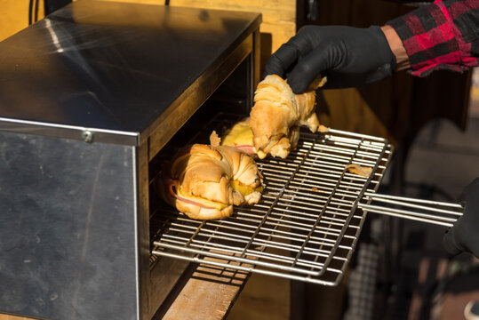 croasant with ham and cheese coming out of the oven in a mobile cafeteria, food and beverage concept