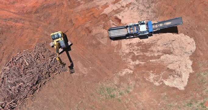 Construction site view with work wood chipping machine the chipper process on aerial top