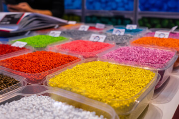 Plastic recycling, renewable resource - heap of colorful secondary polystyrene, polyethylene,...