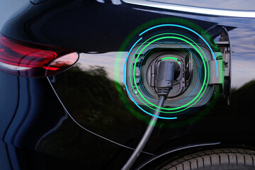 close-up of part of black car charging energy, replenish battery charging station, alternative...