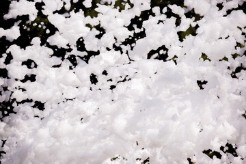 White lather. Background or texture of white foam with copy space. Fun foam parties summer entertainment festival in the water park. White bubbles on a black background.