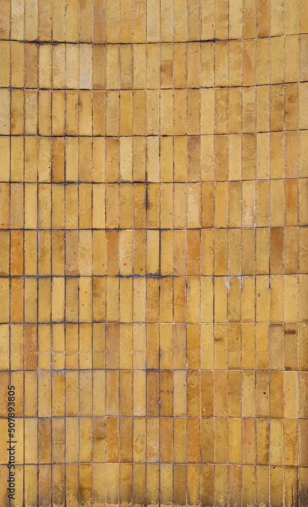 Poster wall made of weathered and dirty yellow and orange tiles or blocks. front view. high resolution full