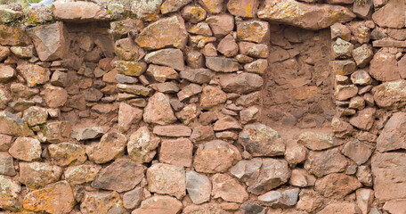 Openings in rock wall in Ancient Archaeological pikillaqta site in Cusco Peru