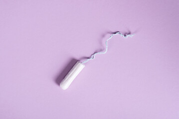 female tampon on a pastel lilac background. flat ley copy space
