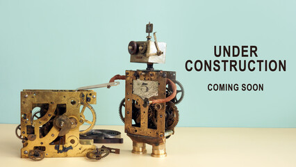 The robot repairs the mechanism and the inscription under construction coming soon.