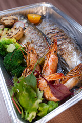 assorted fish and shrimp in a metal box