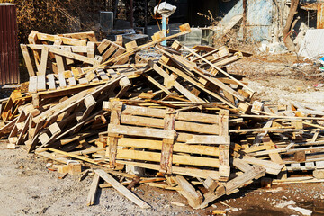 broken transport pallets stacked in a pile