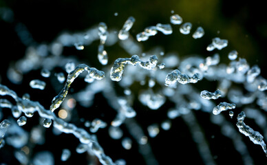 Drops of water splash blue water on a green background of nature, concept of freshness drink,...