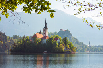 Obraz premium Alpine Bled lake in Slovenia, amazing nature and scenic landscape with church on island and castle on a cliff.