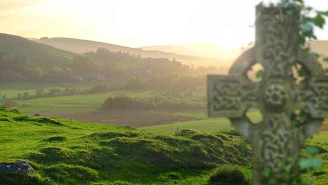 A Celtic Cross Gravestone In Coming Into Focus In The Foreground Of The Beautiful Scottish Countryside