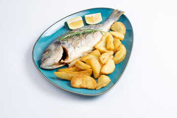 Grilled fish on platter isolated on white. Top view of whole roasted dorado, cutout for menu