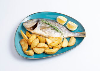 Grilled fish on platter isolated on white background. Top view of whole roasted dorado, cutout for menu